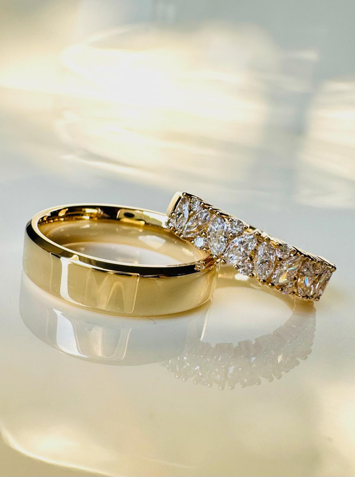 Jewellery designer sketching a bespoke engagement ring with gemstones and precision tools